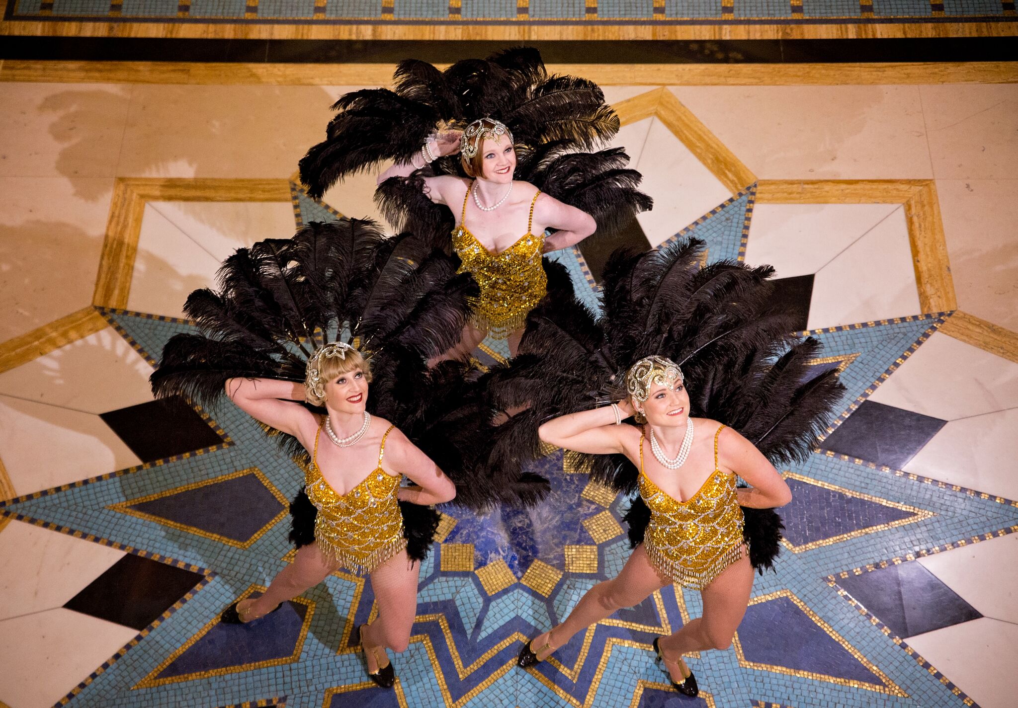 Vintage Dancers gatsby dance showgirls act hire events.jpeg Three vintage gatsby dancers in gold sequins dancing with black feather fans